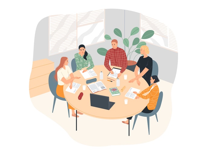 A group of students at the table are studying