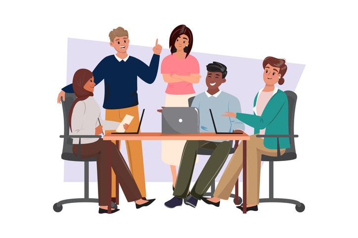 Happy business team at the desk discussing business