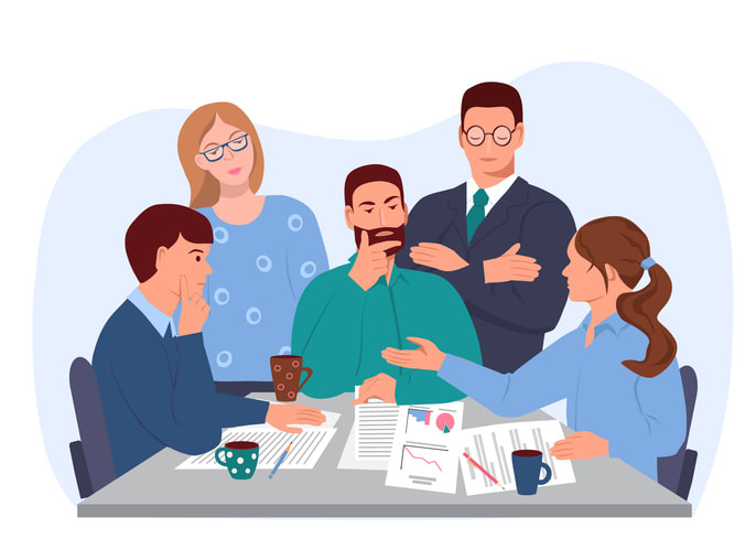 Men and women discuss business issues at the table