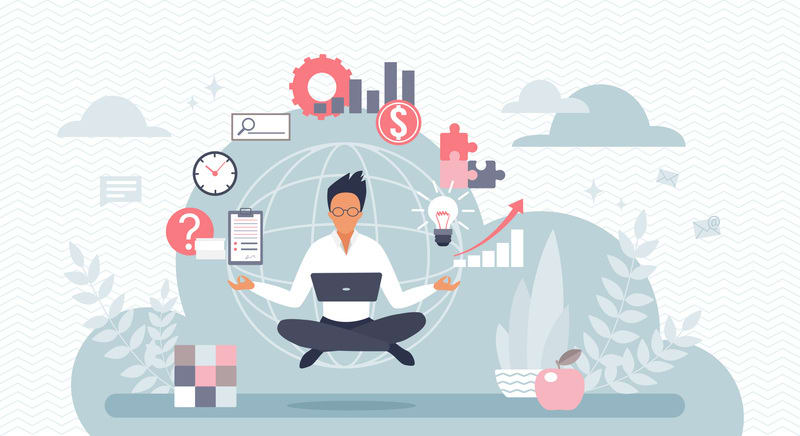 Multitasking businessman in lotus pose working with laptop