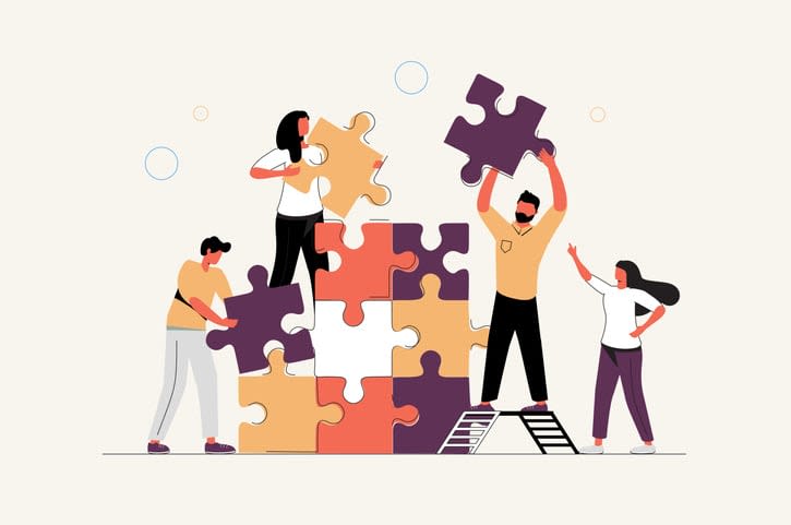 people connecting puzzle elements