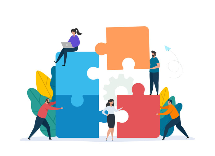 People working together with giant puzzle elements