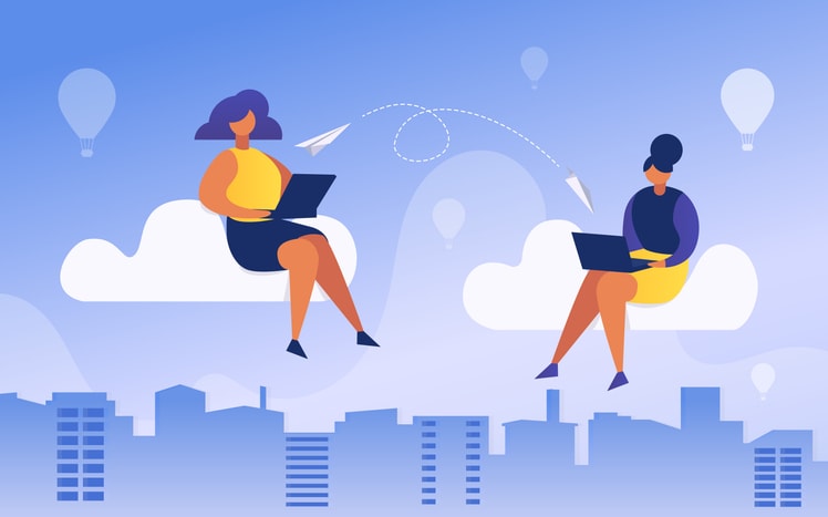 Two people sitting on clouds using laptops with city skyline and hot air balloons in the background